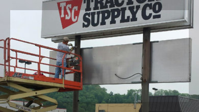 Scissor Lift Working on a Sign